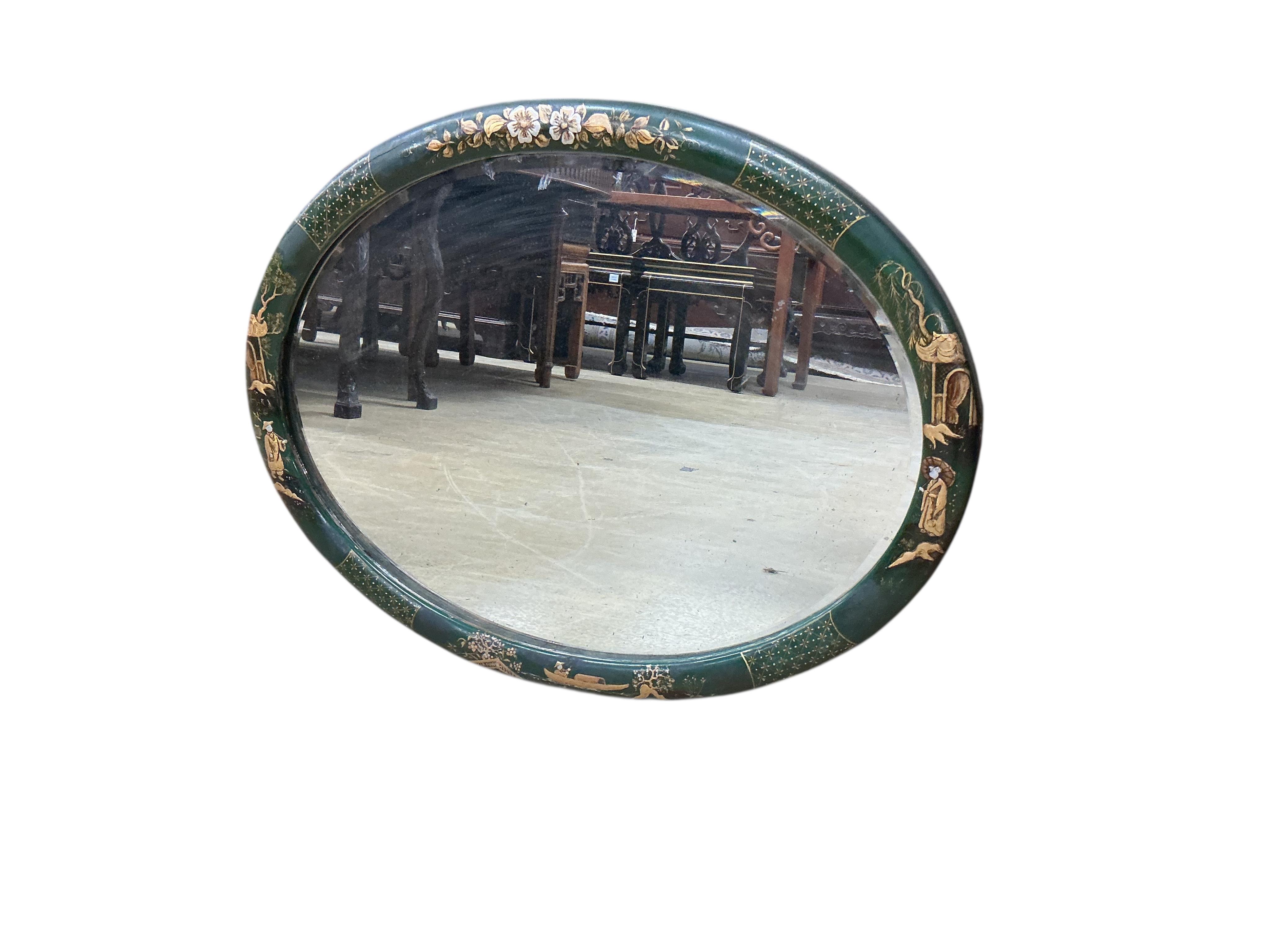 An early 20th century oval chinoiserie lacquer wall mirror, width 68cm, height 53cm